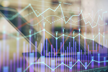 Forex graph hologram on table with computer background. Double exposure. Concept of financial markets.