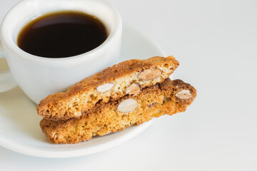 Italian cantucci with almonds with a cup of espresso. Biscotti. Traditional cantuccini. Homemade Italian sweets biscuits (cookies). Italian dessert. Side view.