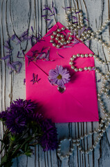 pink paper envelope with flowers and pearls