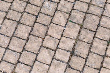 Paving slabs square with rounded edges. Abstract background. Gray paving slabs in the form of squares. Tile floor textures background. Detail of a textured light brown stone sidewalk. Pattern floor.