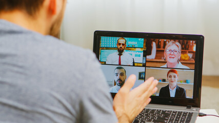 Man on a video call with work colleagues during self isolation.
