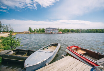 Recreation facility in the distance with boat stop and calm flowing and two boats