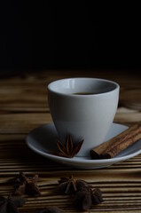 espresso on wooden background with star anise and cinnamon