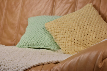 Fototapeta na wymiar knitted pillow and handmade plaid
