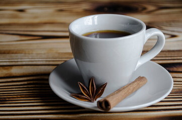 espresso on wooden background with star anise and cinnamon