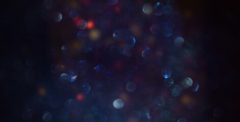 background of abstract glitter lights. gold, blue and black. de focused