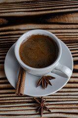 espresso on wooden background with star anise and cinnamon