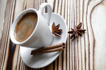 espresso on wooden background with star anise and cinnamon