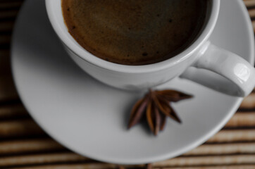 espresso on wooden background with star anise and cinnamon