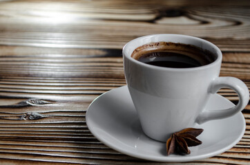espresso on wooden background with star anise and cinnamon