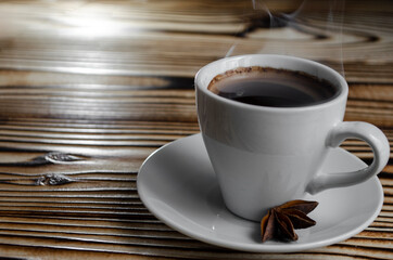 espresso on wooden background with star anise and cinnamon