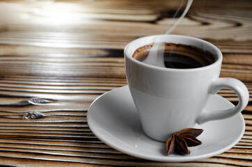 espresso on wooden background with star anise and cinnamon