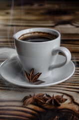 espresso on wooden background with star anise and cinnamon