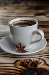espresso on wooden background with star anise and cinnamon