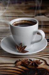 espresso on wooden background with star anise and cinnamon