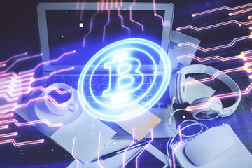 Multi exposure of blockchain and crypto economy theme hologram and table with computer background. Concept of bitcoin cryptocurrency.