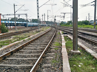 Fototapeta na wymiar Close Up of Indian Railway Tracks low angel view from a rails sleepers near railway station platform during day time in Howrah Station car shed area. Kolkata India South Asia Pacific March 18, 2020