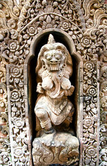 Various stone statues local deities in a beautiful garden in Bali, Indonesia.