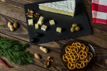 Camembert cheese. cheese dish with olives, herbs, snacks