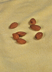 multiple almonds on a yellow background