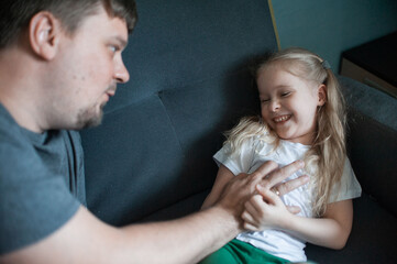 dad plays at home with his children: daughters, son