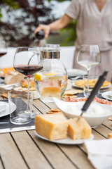dining table with wooden chairs set on the terrace with beautiful italian landscape. food concept