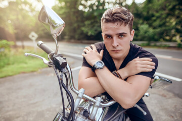Obraz premium portrait of a guy sitting on a motorcycle 
