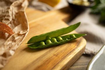 Pellets of green peas on wooden background