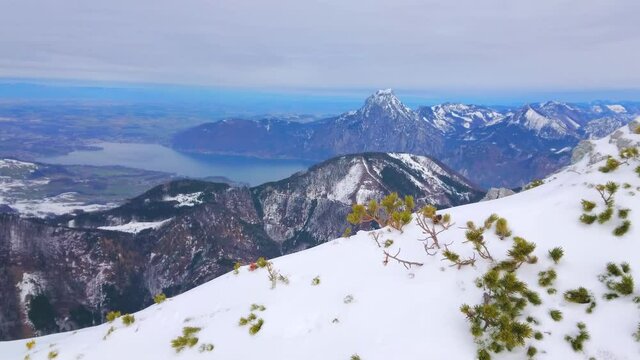 The view from the snowy top of Alberfeldkogel mount of Feuerkogel ski resort on the Traunsee lake valley and Apine slopes around it, Salzkammergut, Austria