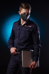 a handsome guy in a police uniform with a laptop on his face and a medical mask . English translation of Police 