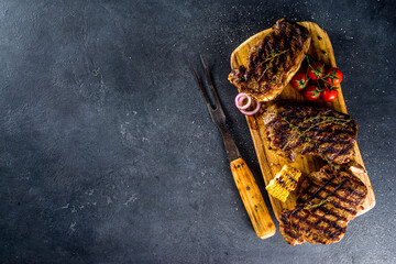 Cooking meat background. Fresh grilled meat  on dark grey table background. Top view. copy space