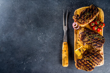 Cooking meat background. Fresh grilled meat  on dark grey table background. Top view. copy space