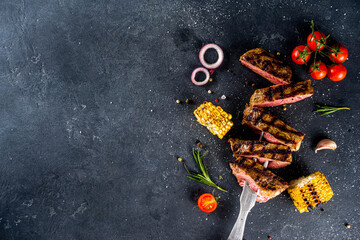 Cooking meat background. Fresh grilled meat  on dark grey table background. Top view. copy space