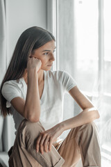 Beautiful young woman portrait behind window