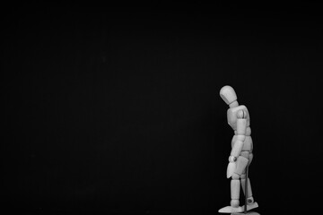 wooden mannequin standing on black background with walking man pose
