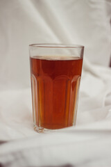 glass with tea on a white vintage background and table
