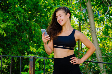 Sport girl with phone in park