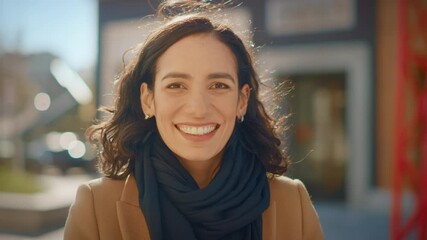 Portrait of a Gorgeous Dark Haired Hispanic Woman Smiling Charmingly while Standing in the Middle of Modern Urban City Landscape, Wearing Spring Coat