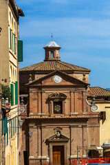 Streets and houses and sculptues in Siena Italy