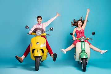 Full length photo of crazy lady guy couple drive two retro moped travelers traffic jam easy way spread legs raise arms rejoicing formalwear vintage clothes isolated blue color background