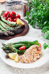Fried cod fillet with green asparagus
