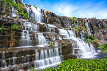 Fototapeta premium Waterfall early winter afternoon with water flowing over rocks creating spectacular beauty for the most beautiful water line highlands