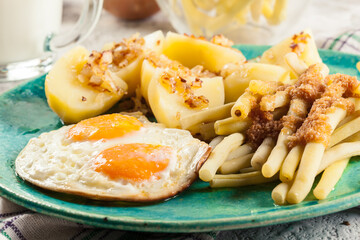 Fried eggs with boiled potatoes and yellow string beans