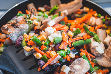 Assorted frozen vegetables in a pan in a sunflower
