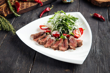 Gourmet roast beef with arugula and tomato salad