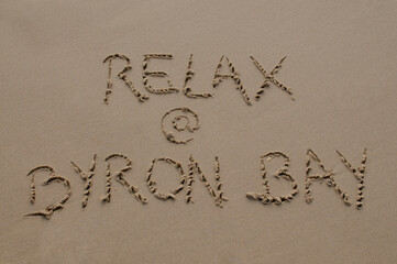 Relax at Byron Bay inscription in the sand