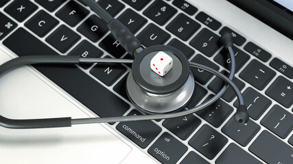 dice on stethoscope placed on laptop keyboard.  The technology quality depended on horoscope concept.