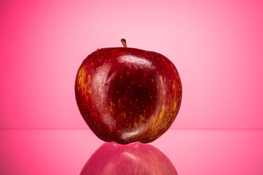 ripe red apple golden simirenko on a red gradient background