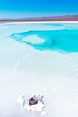 Crystal blue salt water lake pool with mountain range in the background on the horizon in the...