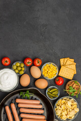 Sausages in pan. Bacon cheese, vegetables, cookies cereal yogurt: ingredients for  continental breakfast